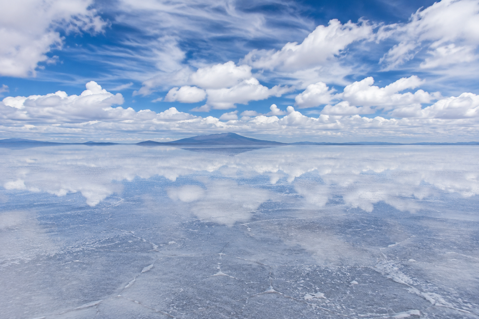 Photorealistic wide-angle photograph of Salar de Uyuni during the rainy season