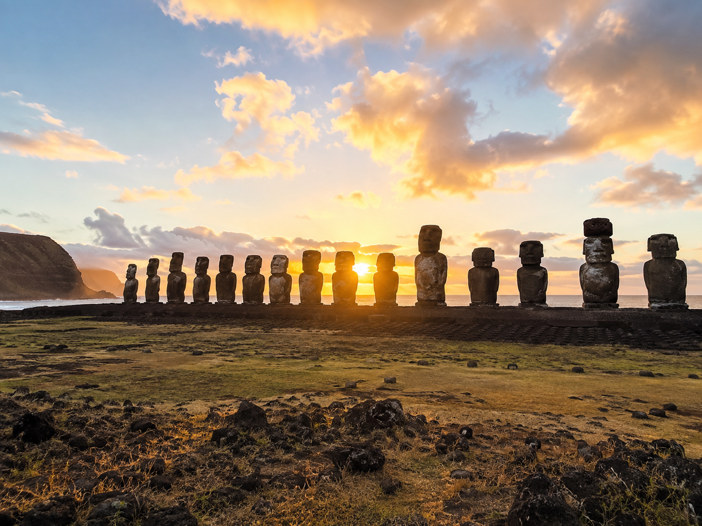 Moai statues standing on Ahu Tongariki against the volcanic landscape of Rapa Nui.