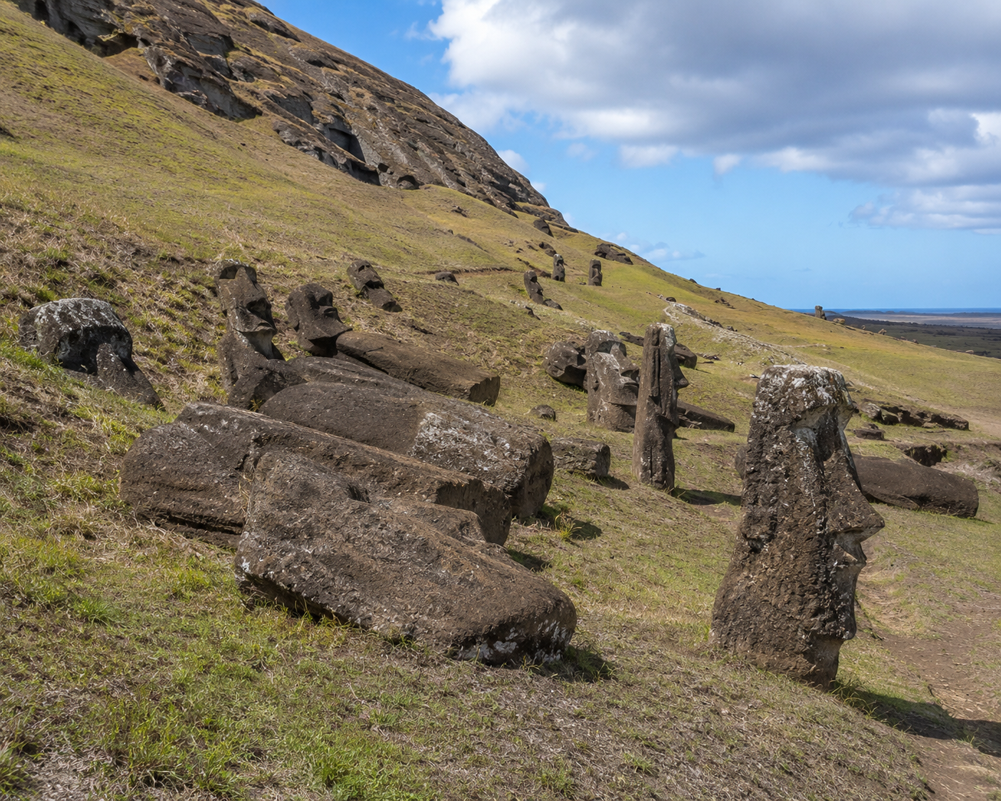Unfinished moai standing on the volcanic slopes of Rano Raraku quarry on Rapa Nui.