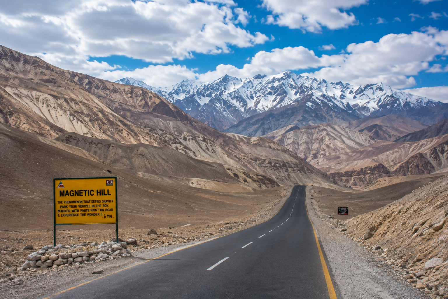 Magnetic Hill road in Ladakh with barren mountains surrounding the apparent uphill slope.