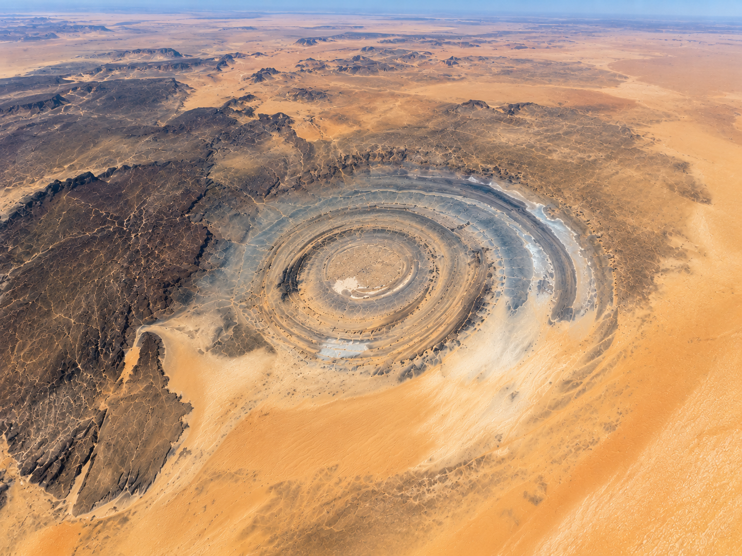 The roughly 40-kilometre-wide Richat Structure spreads across an open section of the Sahara.