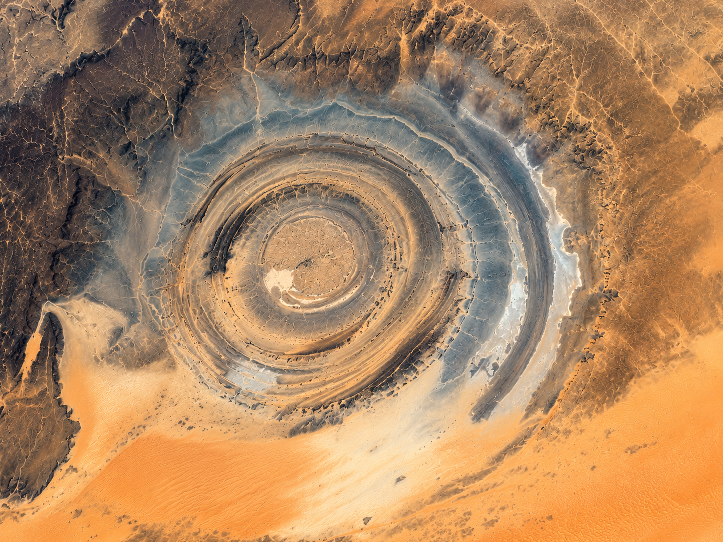 Contrasting rock colours and exposed ridges make the circular Richat Structure easy to distinguish from the surrounding Sahara.
