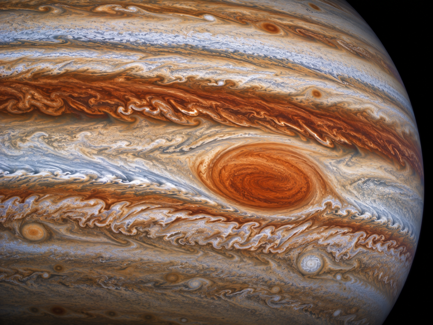 Jupiter’s powerful jet streams surround the Great Red Spot and help keep the storm within a narrow atmospheric region.