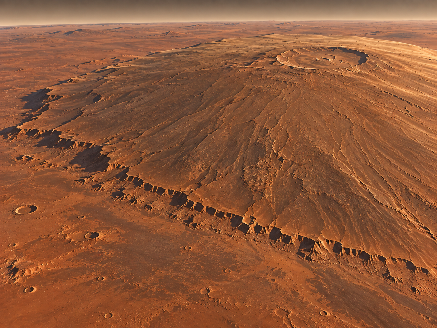 Olympus Mons spreads across a huge broad base with very gentle slopes and a prominent basal escarpment.