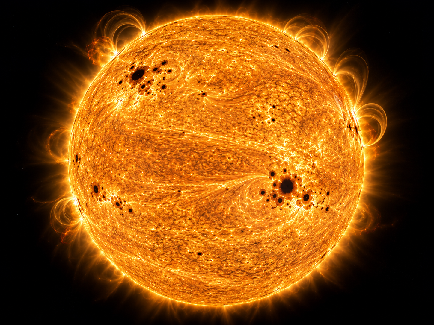 The Sun shows sunspots and subtle differences in surface activity across its rotating plasma layers.